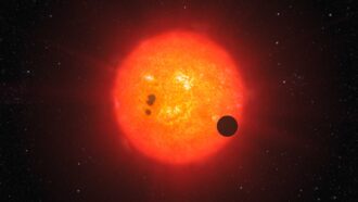 An illustration of exoplanet GJ 1214b and its star.