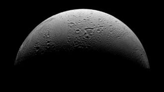 Enceladus, the moon of Saturn, shown partly illuminated against the backdrop of space