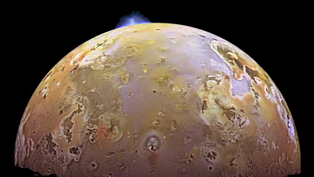 A volcano erupts (blue) on Jupiter’s innermost moon, Io, in this picture from NASA’s Galileo spacecraft.