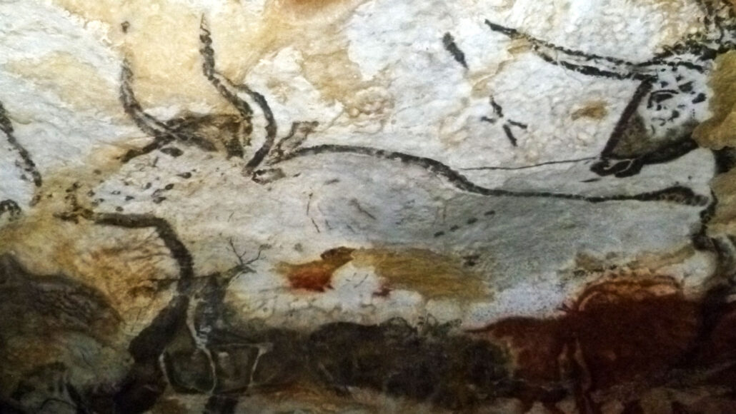 A photo of an ancient cave marking of aurochs (similar to modern cattle) with four dots on the animal's torso.