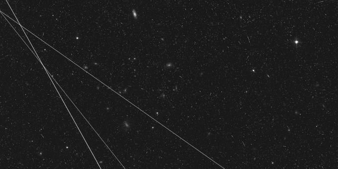 A photo from the Hubble Space Telescope with stars seen and three white lines on the left side of the image.