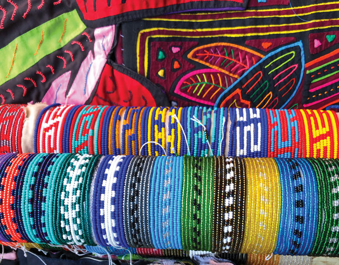 A photo of brightly colored beads and woven fabrics.