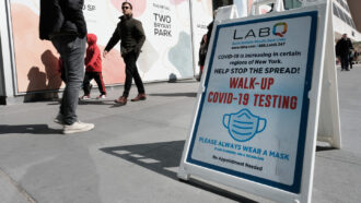 article essay about depression A Lab-Q sign advertising free walk-up COVID-19 testing sits on a public sidewalk. People walk in the background.