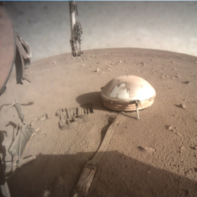 A photo of InSight's clam-shaped seismometer on the surface of Mars.