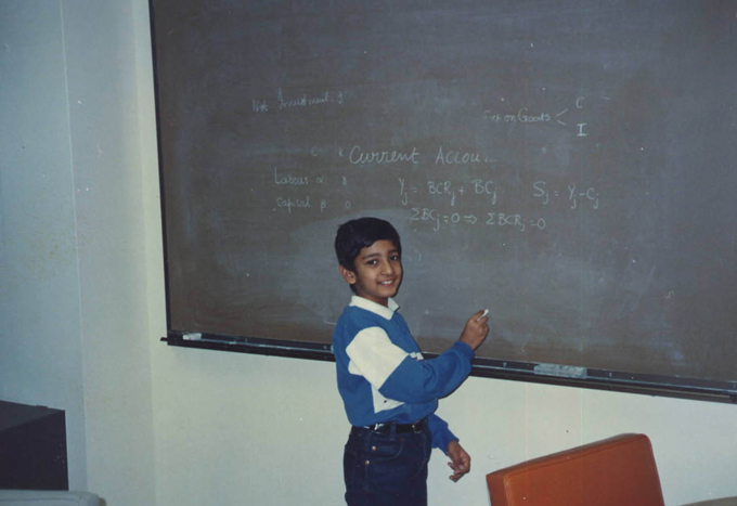 A young Raj Chetty plays in front of a chalkboard at Stony Brook University, where his father, V. K. Chetty, was a visiting professor.