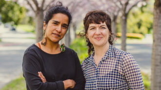 A photo of Ambika Kamath and Melina Packer standing next to each other.