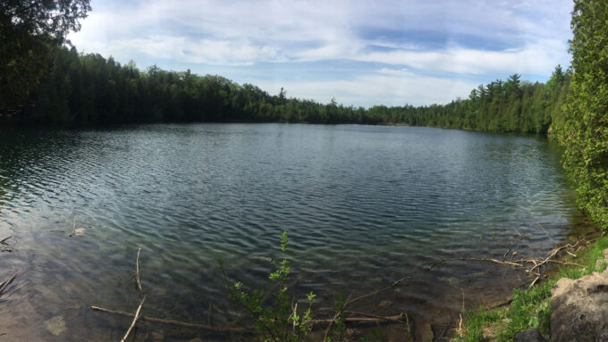 A photo of Crawford Lake with trees surrounding it.