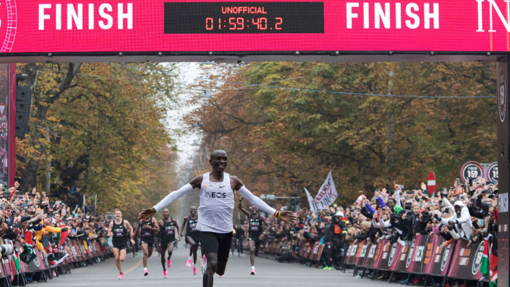 Eliud Kipchoge spreads his arms in jubilation as he finishes a sub 2 hour unofficial marathon in Vienna.