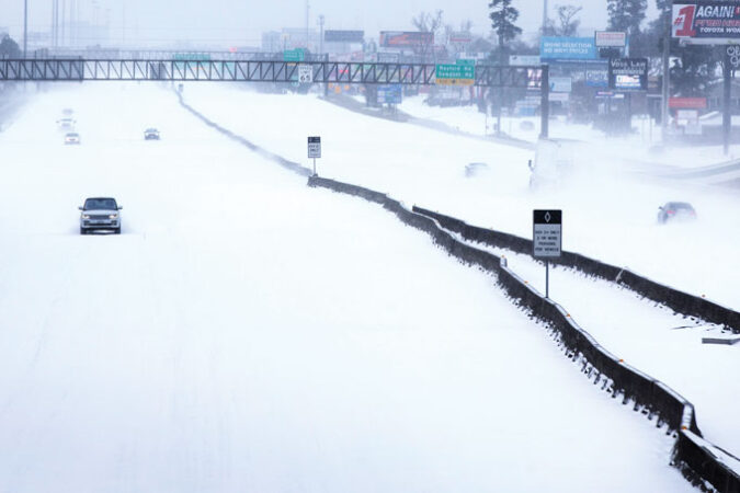 A photo of a Texas highway covered in snow from February 2021 when a deep freeze paralyzed the state's power grid.