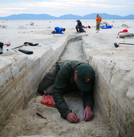 A photo of a man excavating an area for ancient human footprints in White Sands.