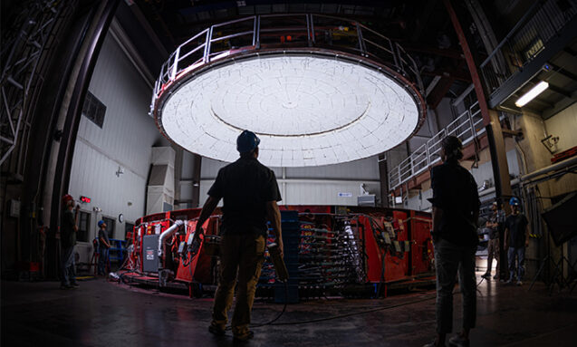 A photo of a 10-meter-wide lid being lowered onto the furnace.