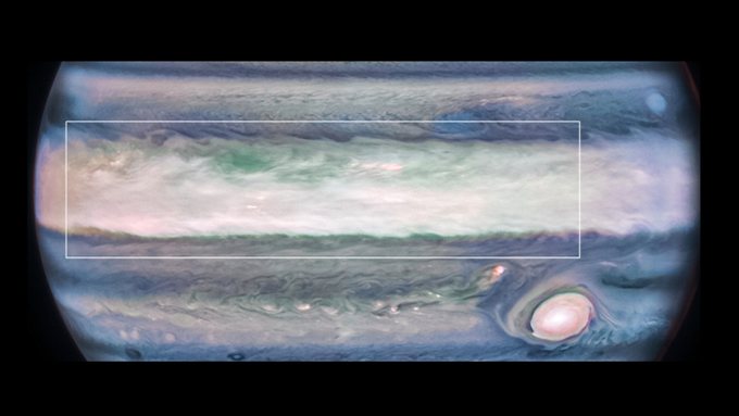 A false-color infrared image of Jupiter where brighter objects lie at higher altitudes. Within an area (box) straddling the planet’s equatorial clouds (white band), researchers noticed a few bright features about 20 to 40 kilometers above the clouds.