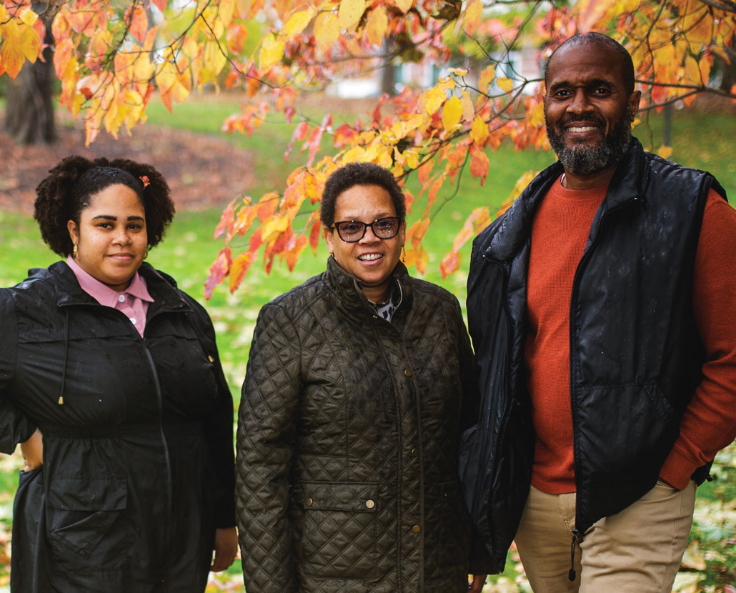 Three healing practitioners from Flint, Michigan, stand outside on a fall day.