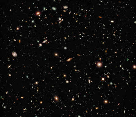 Some of the faintest and reddest objects in this Hubble Space Telescope image, taken in August 2009, may date from only about a half billion years after the Big Bang. The near-infrared image, of a region called the Hubble Ultra Deep Field, was taken with Hubble’s new Wide Field Camera 3. Credit: NASA, ESA, G. Illingworth, R. Bouwens and the HUDF09 Team