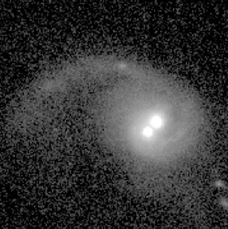 Hubble Space Telescope images of a galaxy forming from the collision of two smaller galaxies showed two bright nuclei near the galactic center. The nuclei could be two supermassive black holes engaged in a cosmic waltz, or they could be the result of a black hole fleeing the galaxy. Credit: Hubble Space Telescope, UC Berkeley