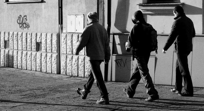 three men walking in step with each other