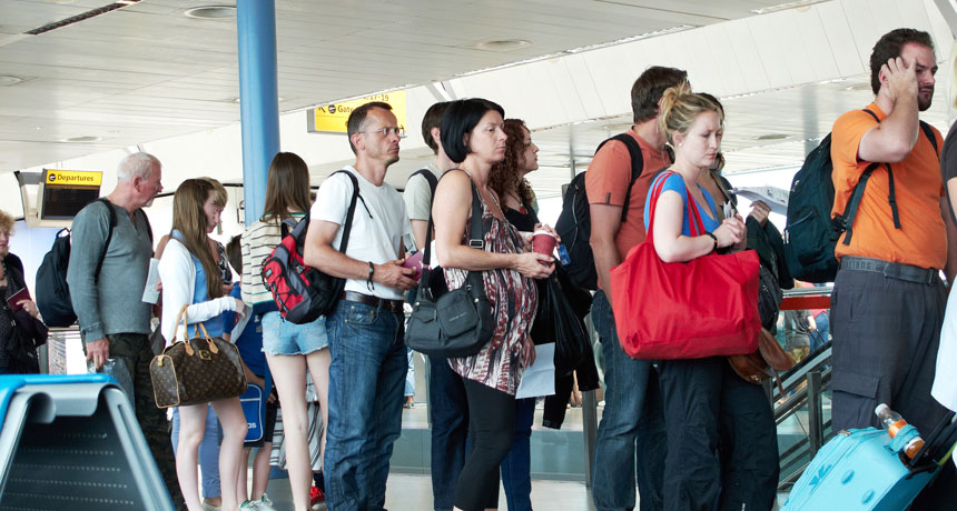 people waiting in line to board plane