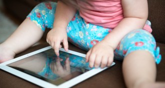 toddler playing on a tablet