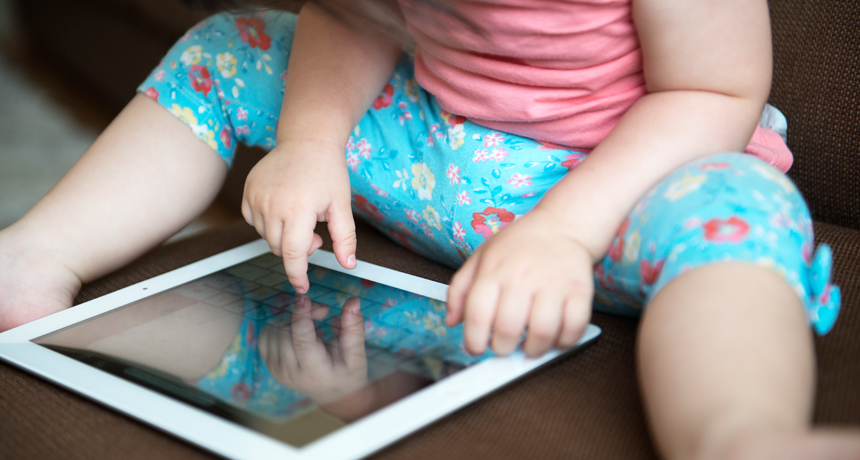 toddler playing on a tablet