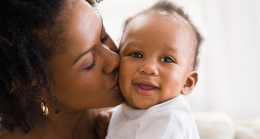 mom kissing baby's cheek