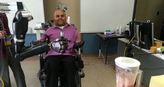 Erik Sorto controls a blender with a robotic arm