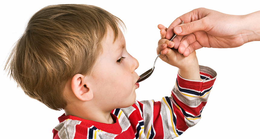 little boy taking medicine