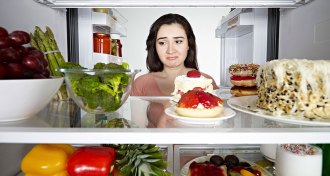woman looking into refrigerator