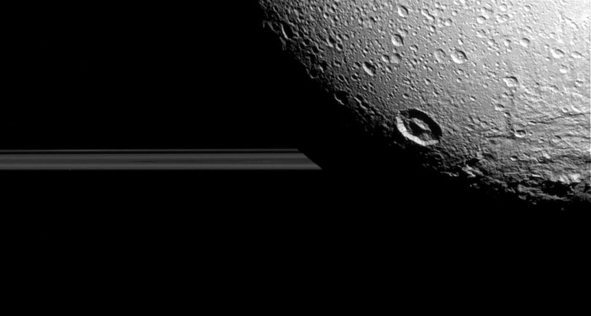 Dione and Saturn's rings, as photographed by Cassini