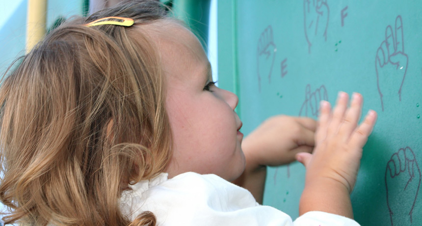 little girl looking at signs