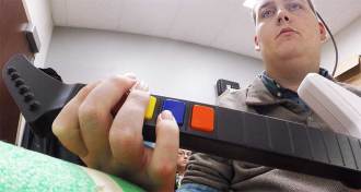 a paralyzed man playing a guitar video game