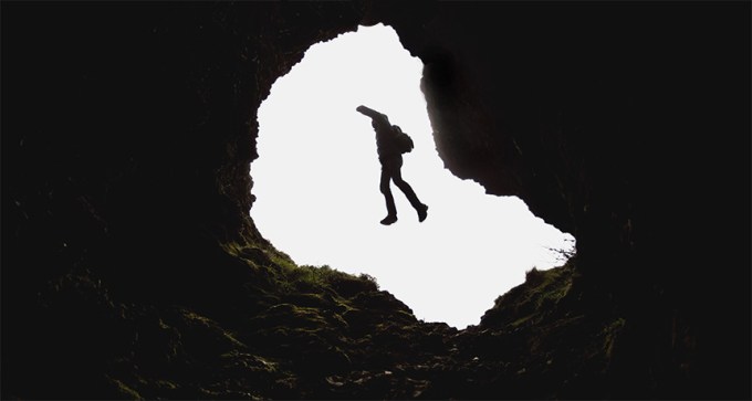 person falling through tunnel