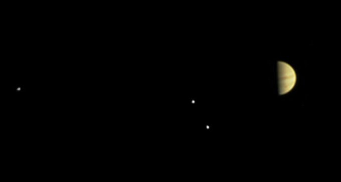Jupiter and three moons, taken by Juno on June 28, 2016