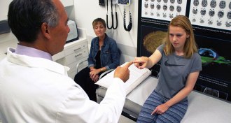 doctor examining teen who had concussion