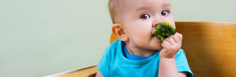 baby eating broccoli