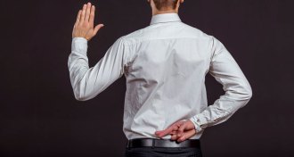 person crossing fingers behind back