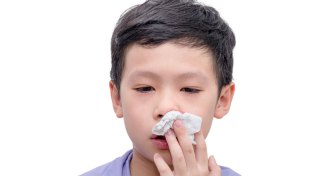young boy stopping bloody nose