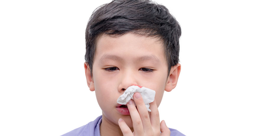 young boy stopping bloody nose