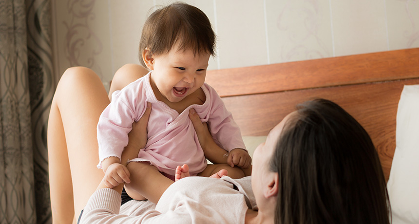 mother and baby laughing and playing