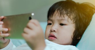 toddler looking at smartphone