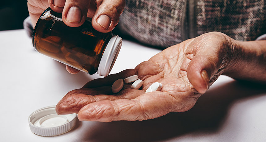 elderly person taking pills