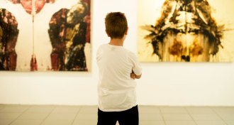 kid looking at paintings