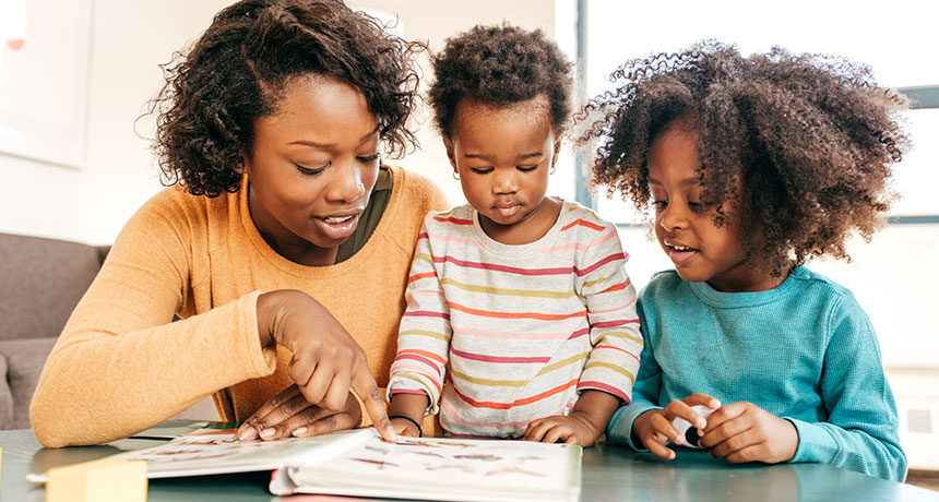 parent reading to two kids
