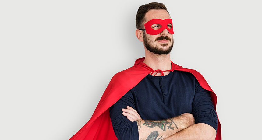 man in superhero costume striking a power pose