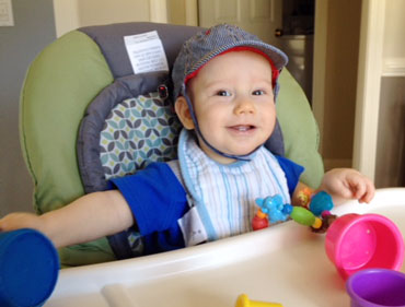 baby wearing hat with cameras