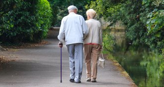 elderly man and woman walking