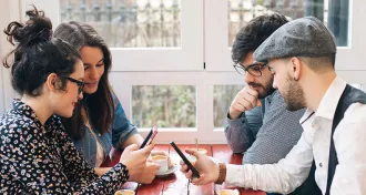 people looking at Twitter on their phones