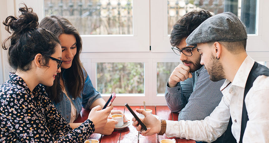 people looking at Twitter on their phones