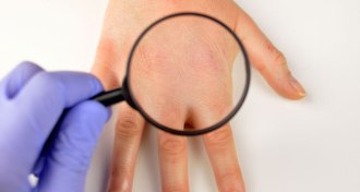 hand with magnifying glass