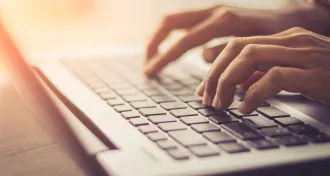 photo illustration of person typing on a laptop