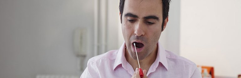 man swabbing his cheek